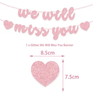 Pink glitter We Will Miss You banner and heart party decorations for farewell event.