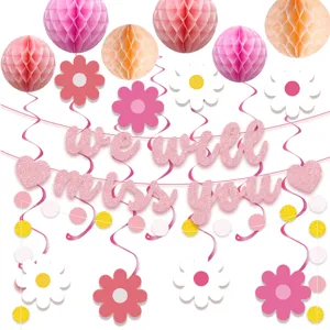 Pink retirement party decorations set with honeycomb balls, daisy hanging swirls and banner.