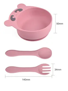 Ensemble bol à ventouse et cuillère fourchette pour bébé en rose avec motif d'ours.