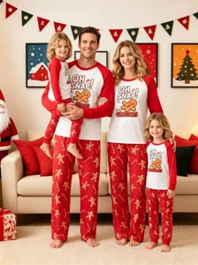 Family Christmas pajama detail showing cute gingerbread print long sleeve top and red pants.
