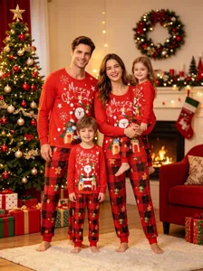 Cozy family Christmas pajamas detail showcasing cute Santa prints and festive red plaid pants.