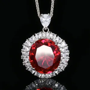 Vista detallada de un collar con colgante de piedra roja ovalada y circonitas brillantes.