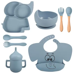 Kit de repas pour bébé en silicone avec assiette éléphant, bol, cuillère, fourchette et bavoir.