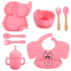Kit d'alimentation bébé en silicone rose avec assiette éléphant, bol, cuillère, fourchette et bavoir.