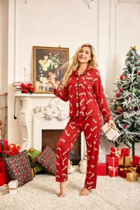Close-up detail of women's red Christmas candy cane print long-sleeve pajama set top.