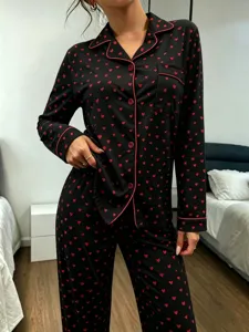 Women's black and red heart print long sleeve button-down pajama set detail fabric.