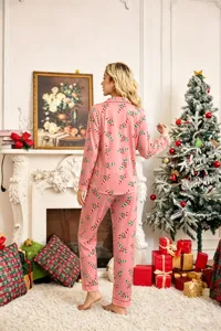 Christmas pajama scene detail, pink loungewear with candy cane pattern near tree