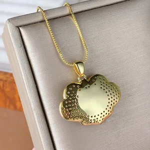 Gold plated ruyi lock pendant necklace close up, delicate box chain jewelry detail shot.