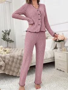 Detail shot of women autumn winter pink ribbed knit pajama set with black lettuce trim.
