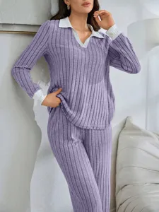 Detailed shot of a cozy purple ribbed lounge set with white contrast collar and cuffs.