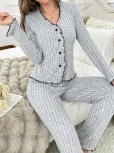 Grey ribbed loungewear set detail showing the delicate black lettuce trim V-neck and button closure.