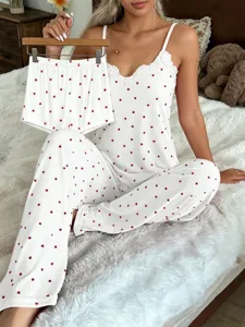 Charming heart print camisole and pants pajama set featuring delicate lace trim details.