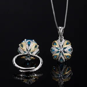 Detailed view of luxury simulated aquamarine gemstone ring and necklace jewelry set.