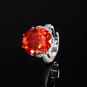 Closeup of luxury orange oval gemstone ring with sparkling pave diamonds and adjustable band.