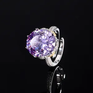 Close-up detail of luxury oval purple gemstone ring with sparkling paved diamond band.