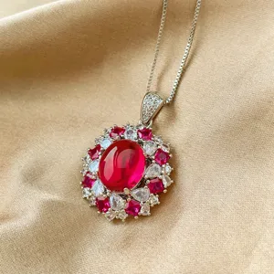Closeup of the stunning pigeon blood red cabochon corundum pendant with sparkling halo.