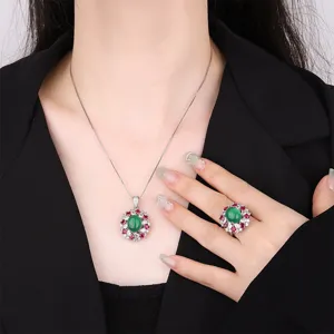 Exquisite green gemstone jewelry set with necklace and ring featuring stunning cluster design.