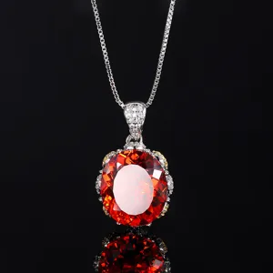 Close-up detail of luxury orange-red oval gemstone pendant necklace with brilliant sparkle.