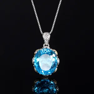 Close-up detail of a sparkling oval blue gemstone pendant necklace with delicate pavé bale.