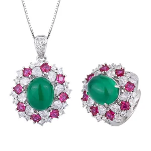 Silver tone jewelry set featuring oval green center stone and red and white crystal halo.
