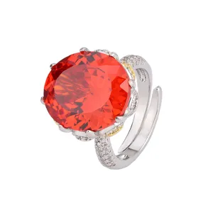 Luxury oversized oval orange red gemstone adjustable ring with sparkling crystal paved band.