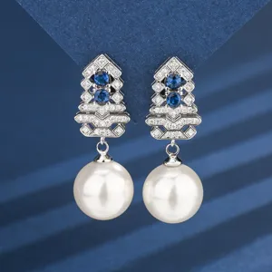 Elegant pearl drop earrings with geometric sapphire and diamond-paved studs for women.