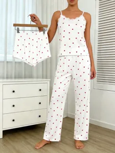 Detail view of white pajama set featuring cute red hearts and delicate lace trim.