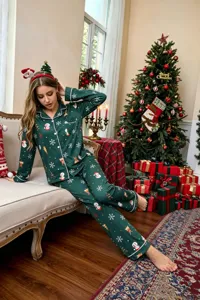 Detailed shot of Christmas green pajama set featuring cute snowman and reindeer prints on model.
