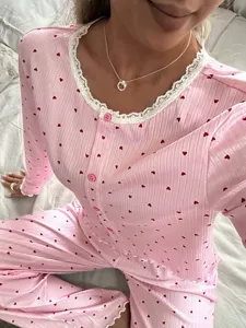 Set pigiama rosa a maniche lunghe da donna, stampa cuori con delicati dettagli in pizzo.