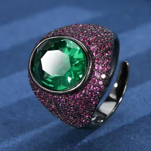 Detailed view of a bold chunky oval green gemstone ring with pink pavé stones in black gold.
