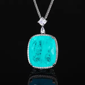 Detailed close-up of a large cushion-cut blue gemstone pendant necklace with dazzling stones.