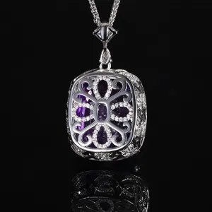 Close-up detail of the ornate silver-toned filigree pendant featuring a rich purple center stone.