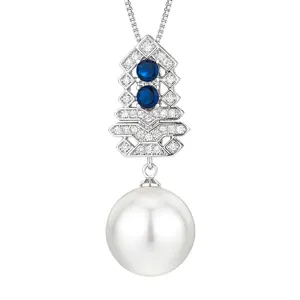 Detailed shot of elegant pearl pendant necklace with blue stones and sparkling rhinestones.