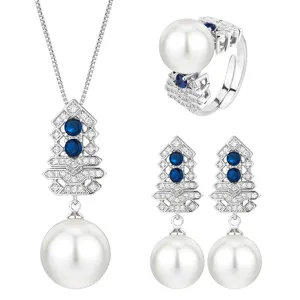 Elegant white pearl and blue stone jewelry set featuring necklace, ring, and earrings.