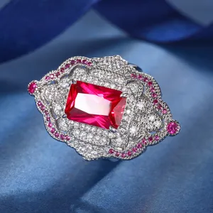 Vintage court style cocktail ring featuring a rectangular red gemstone and sparkling cubic zirconia.
