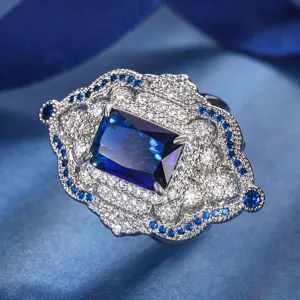 Exquisite vintage court style blue gemstone ring detail, featuring sparkling micro-pave crystals.