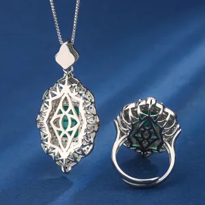 Detailed view of vintage palace style jewelry set necklace and ring with green stone back design.