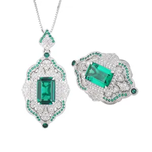 Detailed view of vintage court style emerald cut green gemstone pendant necklace and ring.