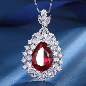 Detailed close-up of a stunning pear-shaped red gemstone pendant necklace with brilliant zirconia.