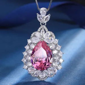 Close-up detail of luxury pink teardrop cubic zirconia pendant necklace with sparkling white stone halo.