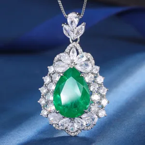 Stunning teardrop green gemstone pendant necklace with sparkling cubic zirconia halo details.