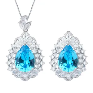Blue pear-shaped gemstone pendant necklace and earrings luxury jewelry set detail shot