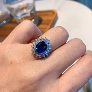 Exquisite vintage oval blue gemstone ring featuring sparkling diamond halo for elegant style.