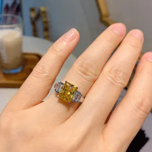 Primo piano di un anello di moda con gemma preziosa gialla rettangolare 8x10mm indossato.