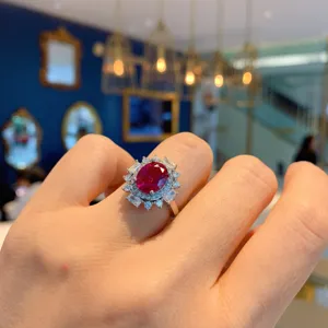 Stunning vintage oval red gemstone cluster ring with sparkling diamond halo for elegant daily wear.