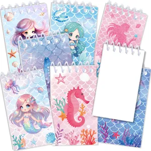 Vista detallada de cuadernos de espiral con bonitos estampados de sirenas y caballitos de mar.