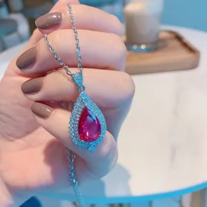 Detailed view of the exquisite pear-cut ruby pendant necklace with sparkling pavé zircon stones.