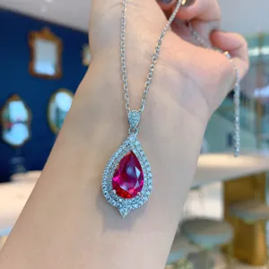 Close-up detail of a stunning pear-cut red ruby pendant necklace with dazzling cubic zirconia.