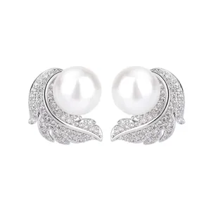 Exquisite feather pearl earrings detail, shiny crystal pavé design, elegant silver finish.