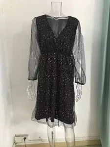 Details of black V-neck mesh long sleeve dress showing sheer fabric and delicate silver speckles.
